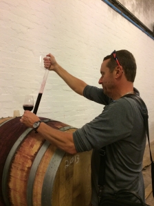 Drinking merlot out of a wooden barrel at Middelvei Winery in South Africa